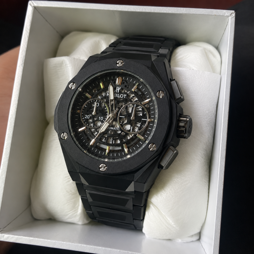 HUBLOT black skeleton watch with black case, three-quarter side angle, in presentation box