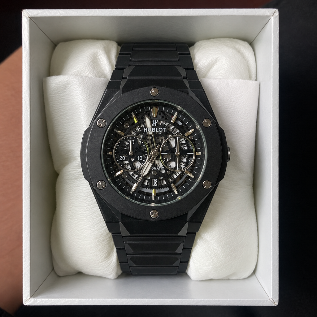 HUBLOT black skeleton watch with black case, flat lay top-down view, in presentation box